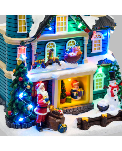 Villaggio "casa con scena natalizia", slitta in movimento oriz. e albero di natale con luci rgb 20xh.23 cm, musica e led Villaggio "casa con scena natalizia", slitta in movimento oriz. e albero di natale con luci rgb 20xh.23 cm, musica e led